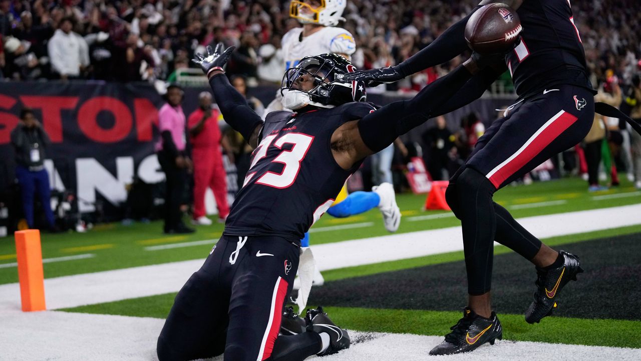 Houston Texans safety Eric Murray (23) celebrates returning an interception for a touchdown against the Los Angeles Chargers during the second half of an NFL wild-card playoff football game Saturday, Jan. 11, 2025, in Houston. (AP Photo/Eric Christian Smith)