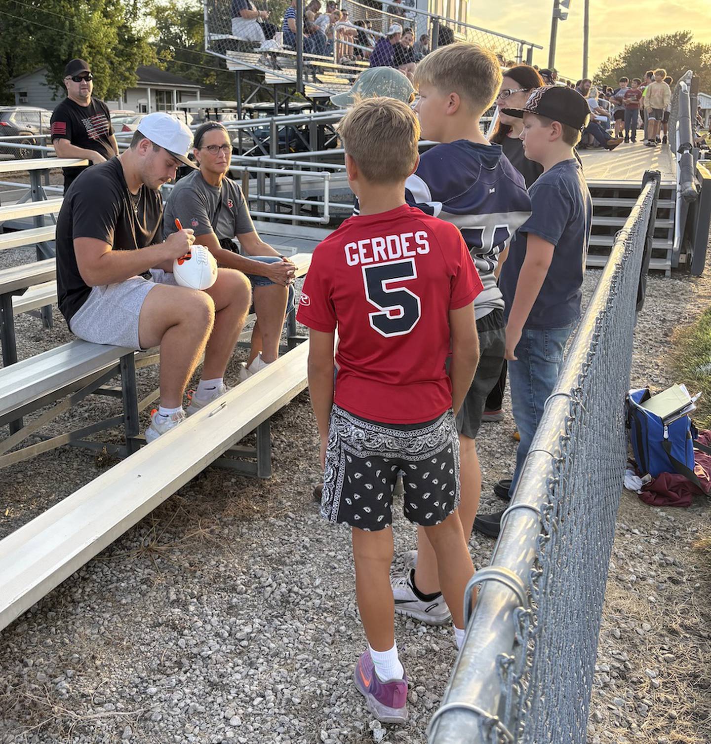 Fieldcrest graduate and Cincinnati Bengals tight end Cam Grandy (left) signs autographs before the Knights' game Friday against Tri-Valley in Minonk.