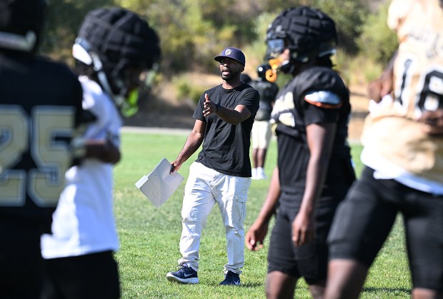 The Jesse Bethel head football coach, Gary Lee, talks to players during practice on Friday. (Chris Riley/Times-Herald)