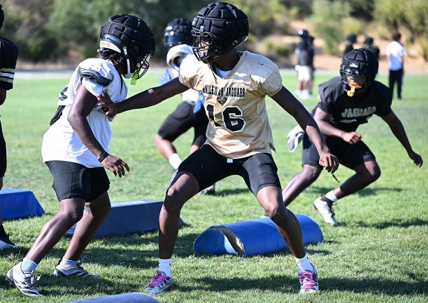 Jesse Bethel's Jermeer Lee-Hicks works on blocking drills during practice on Friday. (Chris Riley/Times-Herald)