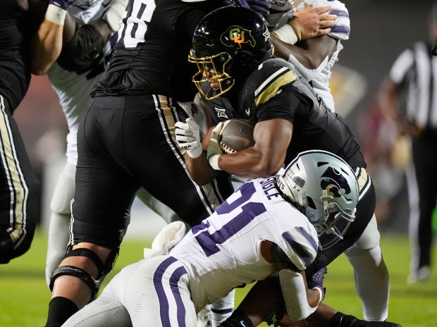 Kansas State safety Marques Sigle, front, tackles Colorado running back Dallan Hayden after a short gain in the first half of an NCAA college football game, Saturday, Oct. 12, 2024, in Boulder, Colo. (AP Photo/David Zalubowski)