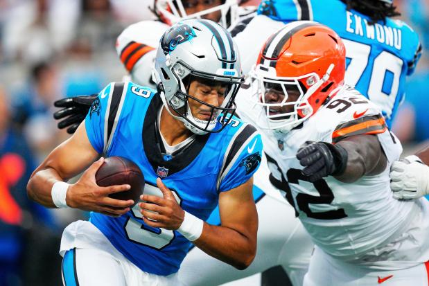 Carolina Panthers quarterback Bryce Young breaks away from Cleveland Browns defensive end Sam Kamara during the first half of a preseason NFL football game on Friday, Aug. 8, 2025, in Charlotte, N.C. (AP Photo/Jacob Kupferman)