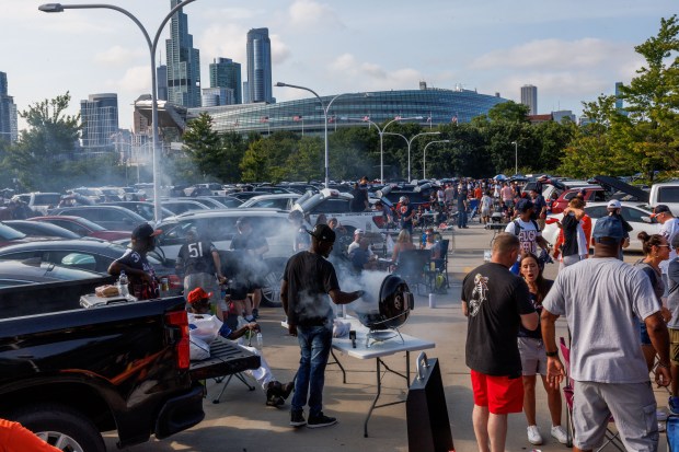 Fans tailgate at a parking garage before the Chicago Bears...