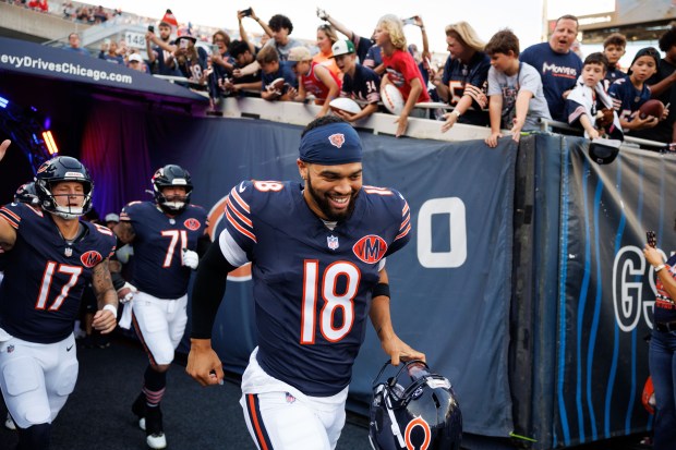 Chicago Bears quarterback Caleb Williams (18) takes the field with...