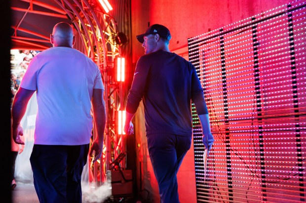 Chicago Bears head coach Ben Johnson walks to the field...