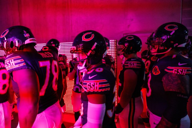 Chicago Bears players walk through a tunnel before taking the...