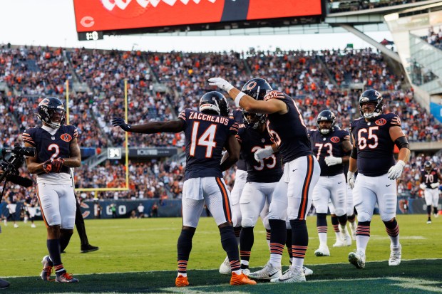 Chicago Bears wide receiver Olamide Zaccheaus (14) celebrates with other...