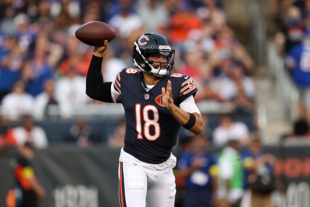 Chicago Bears quarterback Caleb Williams (18) looks before throwing a...