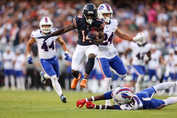 Chicago Bears wide receiver Olamide Zaccheaus (14) breaks a tackle...