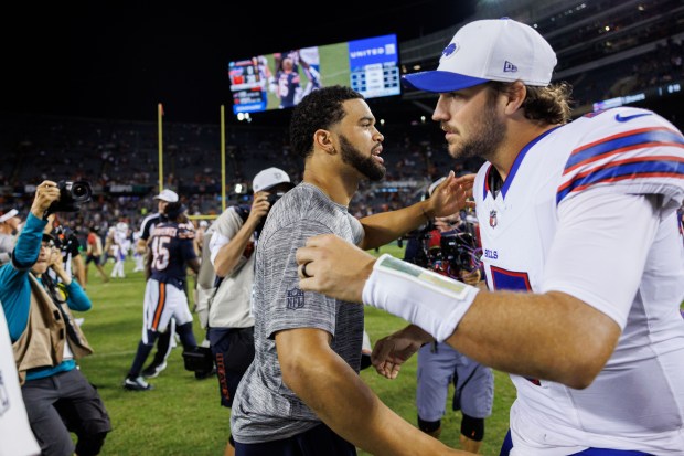 Chicago Bears quarterback Caleb Williams (18) hugs Buffalo Bills quarterback...