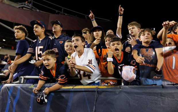 Children yell towards Chicago Bears quarterback Tyson Bagent (17) after...