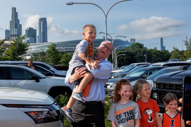 Chicago Bears Chairman George McCaskey picks up 6-year-old Anthony Evans...