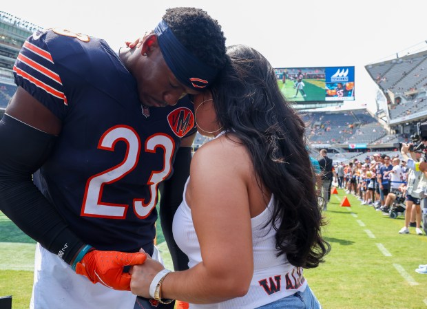 Bears cornerback Jeremiah Walker prays with his girlfriend, Alyssa Olguin, before the start of a game against the Miami Dophins at Soldier Field on Aug. 10, 2025, in Chicago. (Stacey Wescott/Chicago Tribune)