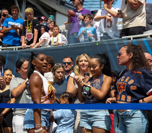 Simone Biles, wife of Chicago Bears safety Jonathan Owens (36) watches her husband warm up before the start of a game against the Miami Dophins at Soldier Field on Aug. 10, 2025, in Chicago. (Stacey Wescott/Chicago Tribune)