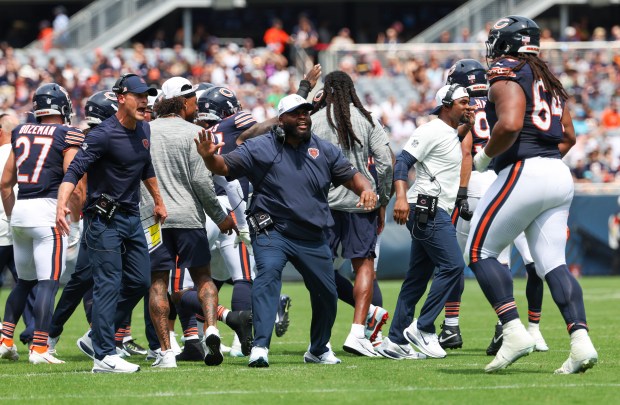 Bears coaches celebrate the Chicago Bears defense stopping the Miami Dophins short of the goal line in the first quarter during a game at Soldier Field on Aug. 10, 2025, in Chicago. The game ended in a 24-24 tie. (Stacey Wescott/Chicago Tribune)