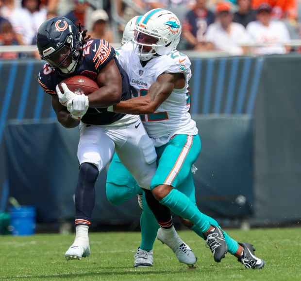 Chicago Bears running back Kyle Monangai (25) keeps moving forward for the first down before being stopped by Miami Dolphins safety Elijah Campbell (22) in the first half of a game at Soldier Field on Aug. 10, 2025, in Chicago. The game ended in a 24-24 tie. (Stacey Wescott/Chicago Tribune)