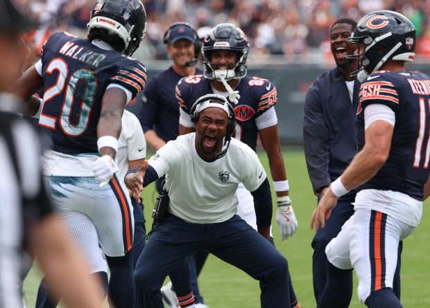 The Chicago Bears sidelines celebrate a 4th quarter touchdown pass from quarterback Case Keenum (11) to wide receiver Jahdae Walker (20)during a game against the Miami Dolphins at Soldier Field on Aug. 10, 2025, in Chicago. (Stacey Wescott/Chicago Tribune)