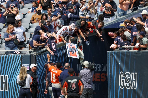 Chicago Bears quarterback Caleb Williams (18) high-fives fans as he walks off the field during Chicago Bears Family Fest at Soldier Field on Sunday, Aug. 3, 2025. (Eileen T. Meslar/Chicago Tribune)