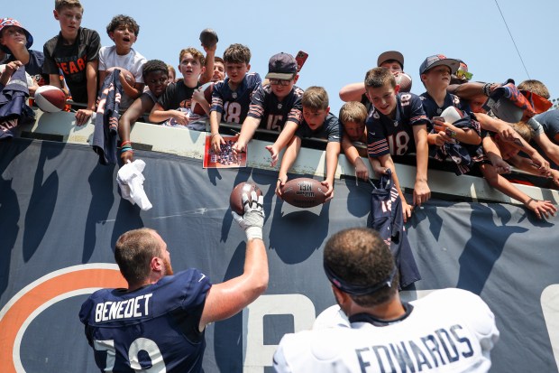 Chicago Bears guard Theo Benedet (79) and Chicago Bears linebacker T.J. Edwards (53) sign autographs for fans at the end of Chicago Bears Family Fest at Soldier Field on Sunday, Aug. 3, 2025. (Eileen T. Meslar/Chicago Tribune)