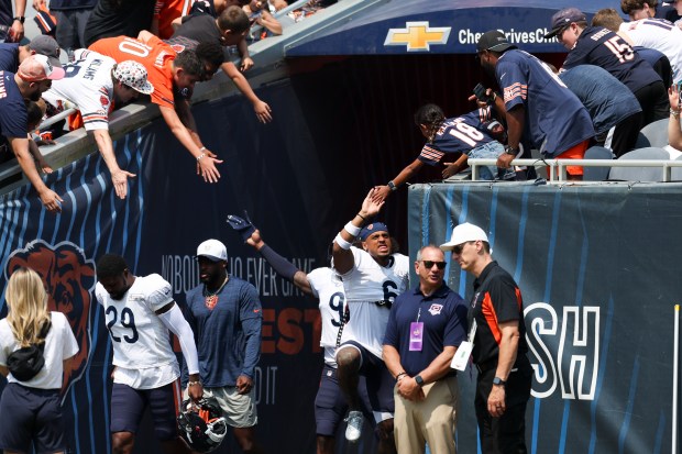 Chicago Bears cornerback Kyler Gordon (6) jumps to high-five a fan during Chicago Bears Family Fest at Soldier Field on Sunday, Aug. 3, 2025. (Eileen T. Meslar/Chicago Tribune)