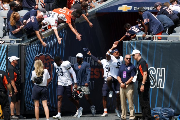 Chicago Bears cornerback Kyler Gordon (6) jumps to high-five a fan during Chicago Bears Family Fest at Soldier Field on Sunday, Aug. 3, 2025. (Eileen T. Meslar/Chicago Tribune)