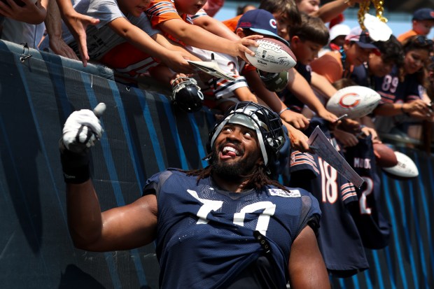Chicago Bears offensive tackle Braxton Jones (70) smiles at a fan at the end of Chicago Bears Family Fest at Soldier Field on Sunday, Aug. 3, 2025. (Eileen T. Meslar/Chicago Tribune)
