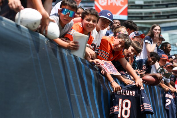 Chicago Bears fans reach out for autographs from players at the end of Chicago Bears Family Fest at Soldier Field on Sunday, Aug. 3, 2025. (Eileen T. Meslar/Chicago Tribune)