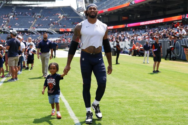 Chicago Bears defensive end Montez Sweat (98) walks off the field with his son Shiloh at the end of Chicago Bears Family Fest at Soldier Field on Sunday, Aug. 3, 2025. (Eileen T. Meslar/Chicago Tribune)