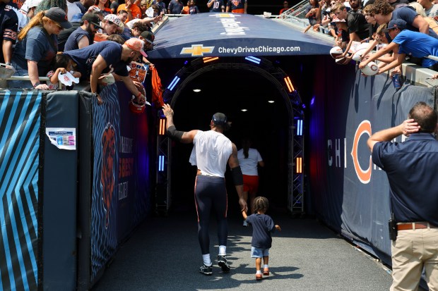 Chicago Bears defensive end Montez Sweat (98) walks off the field with his son Shiloh at the end of Chicago Bears Family Fest at Soldier Field on Sunday, Aug. 3, 2025. (Eileen T. Meslar/Chicago Tribune)