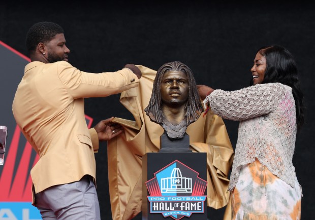 Devin Hester and his mother, Juanita Brown, unveil his Pro Football Hall of Fame bust during the enshrinement ceremony at Tom Benson Hall of Fame Stadium on Aug. 3, 2024, in Canton. (John J. Kim/Chicago Tribune)