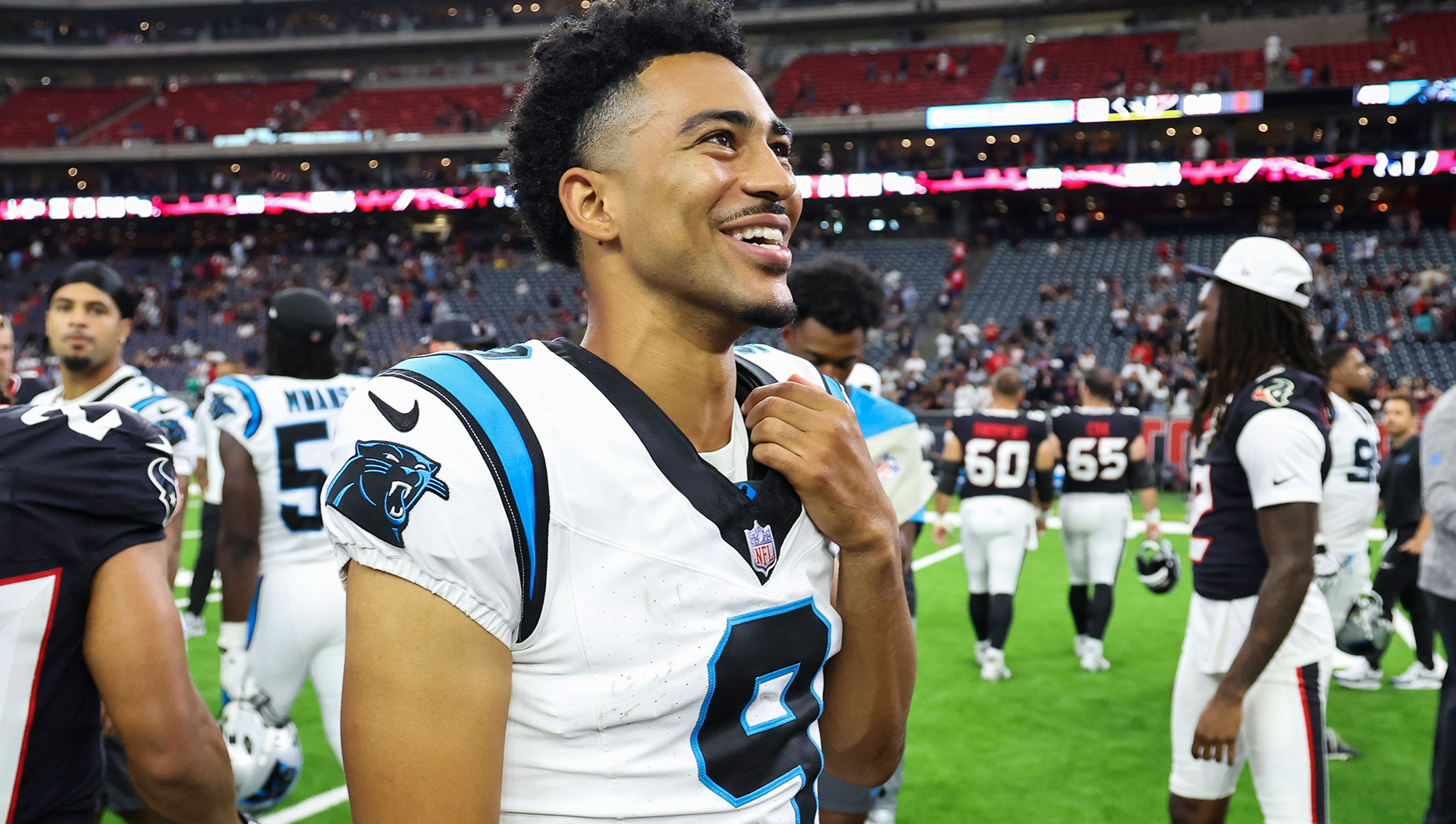 Carolina Panthers quarterback Bryce Young (9) smiles on the field after the game against the Houston Texans at NRG Stadium.