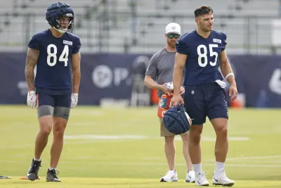Jul 24, 2025; Lake Forest, IL, USA; Chicago Bears tight ends Colston Loveland (84) and Cole Kmet (85) stand on the field during training camp at Halas Hall.