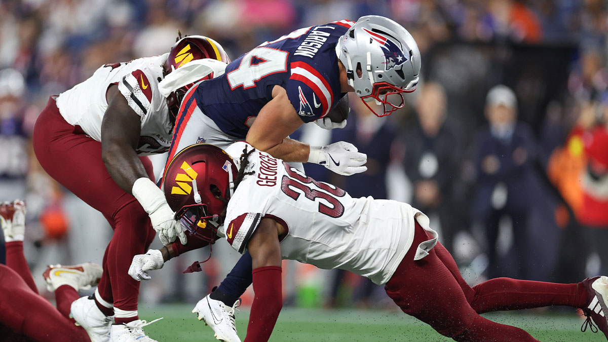 Washington Commanders cornerback Allan George (38) tackles New England Patriots running back Lan Larison (34) during the second half at Gillette Stadium.