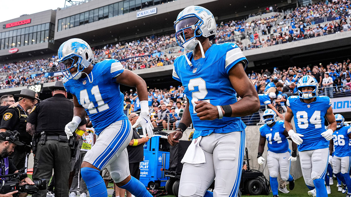 Detroit Lions quarterback Hendon Hooker (2), center, and linebacker Anthony Pittman (41), left, take the field for first half of the Hall of Fame Game against LA Chargers at Tom Benson Hall of Fame Stadium in Canton, Ohio on Thursday, July 31, 2025.