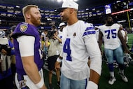 Dallas Cowboys quarterback Dak Prescott (4) talks with former teammate Baltimore Ravens...