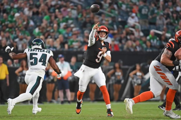 Cincinnati Bengals quarterback Joe Burrow (9) throws a touchdown pass against the Philadelphia Eagles as linebacker Jeremiah Trotter Jr. approaches during the first quarter at Lincoln Financial Field on Thursday, Aug. 7, 2025. (Eric Hartline/Associated Press)