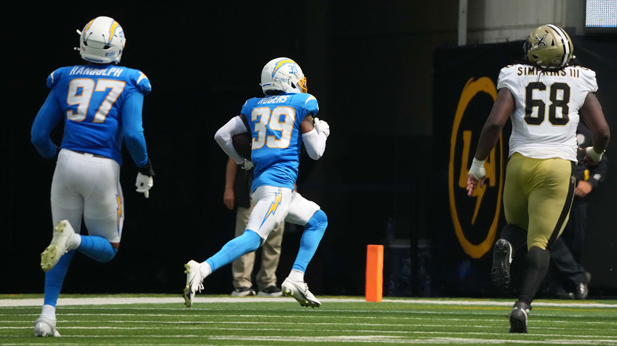 Los Angeles Chargers cornerback Eric Rogers (39) scores after an interception against the New Orleans Saints in the second half at SoFi Stadium.