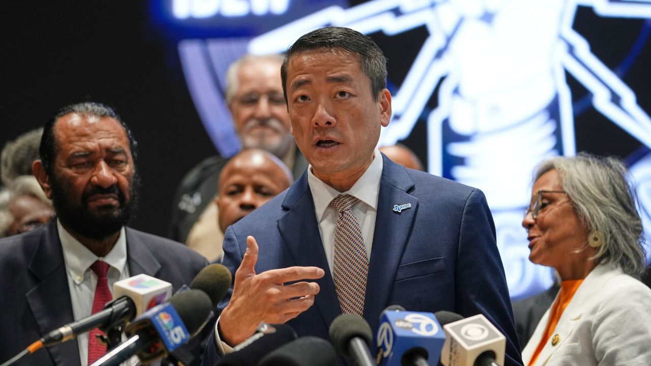 Democratic Texas Rep. Gene Wu, center, surrounded by other Texas House Democrats and Democratic members of Congress, speaks during a press conference at the Democratic Party in Warrenville, Ill., Monday, Aug. 4, 2025. (AP Photo/Nam Y. Huh)
