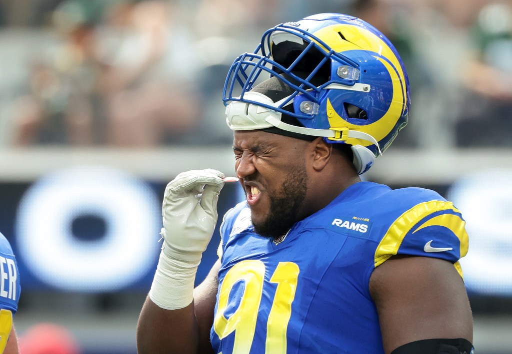 Rams defensive end Kobie Turner takes a sniff of smelling salt during a game against the Packers at SoFi Stadium in Inglewood Sunday.  