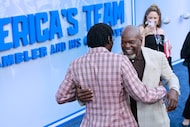 Former Dallas Cowboys Pro Football Hall of Famers Michael Irvin (left) and Emmitt Smith hug...