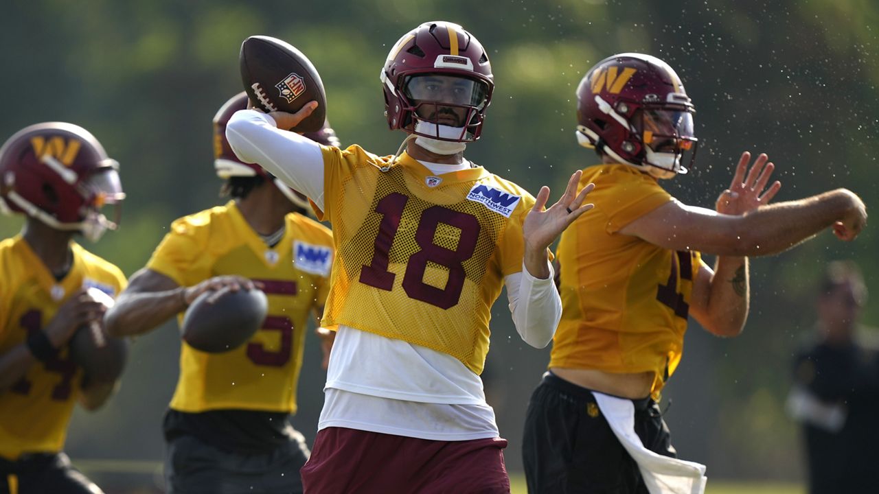 Marcus Mariota, middle, a Saint Louis School graduate, Washington Commanders quarterback Marcus Mariota threw the ball during practice at the team's football training camp on July 27 in Ashburn, Va.