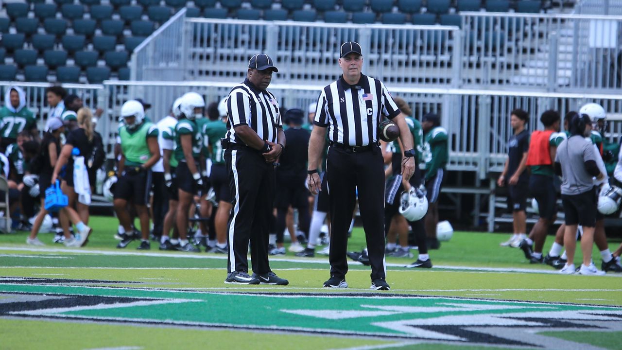 Two officials, part of a full crew assigned to oversee a Hawaii football scrimmage on Saturday, paused at midfield at the Clarence T.C. Ching Athletics Complex.