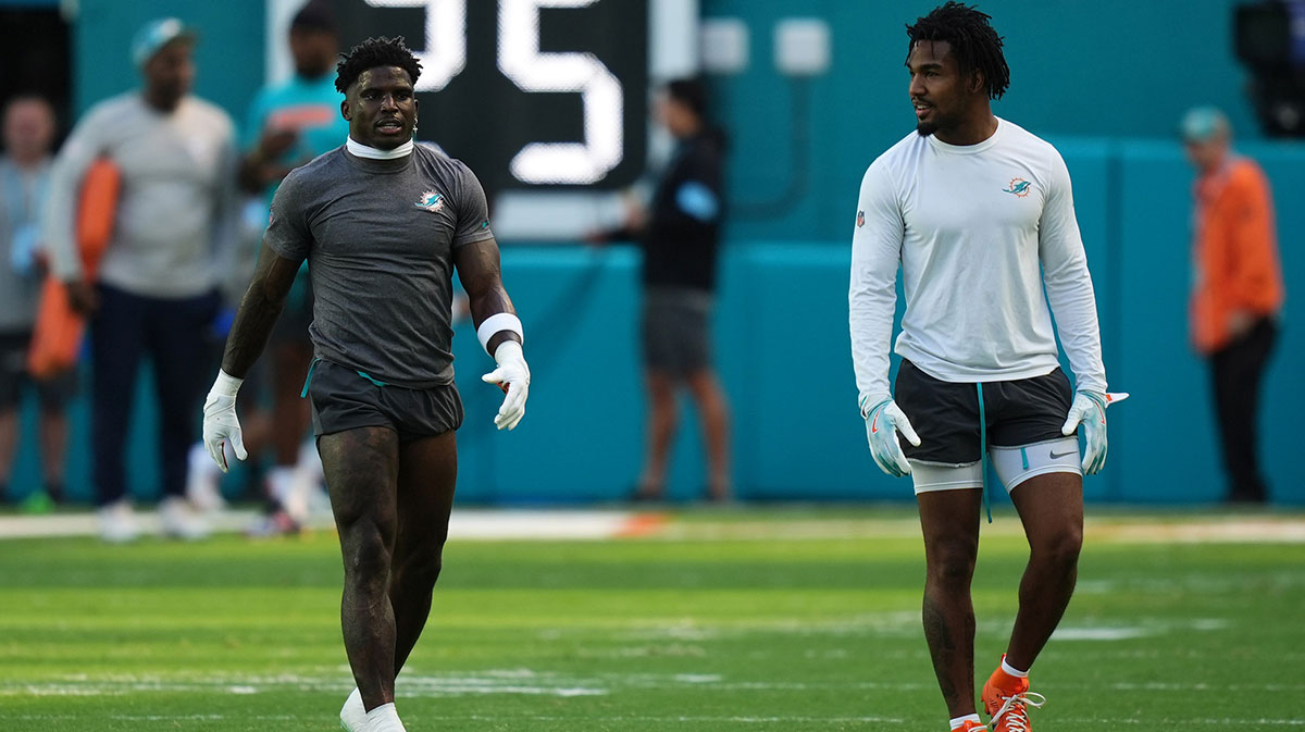 Miami Dolphins wide receiver Tyreek Hill (L) and Miami Dolphins wide receiver Jaylen Waddle (R) walk on the field prior to the game against the New England Patriots at Hard Rock Stadium.