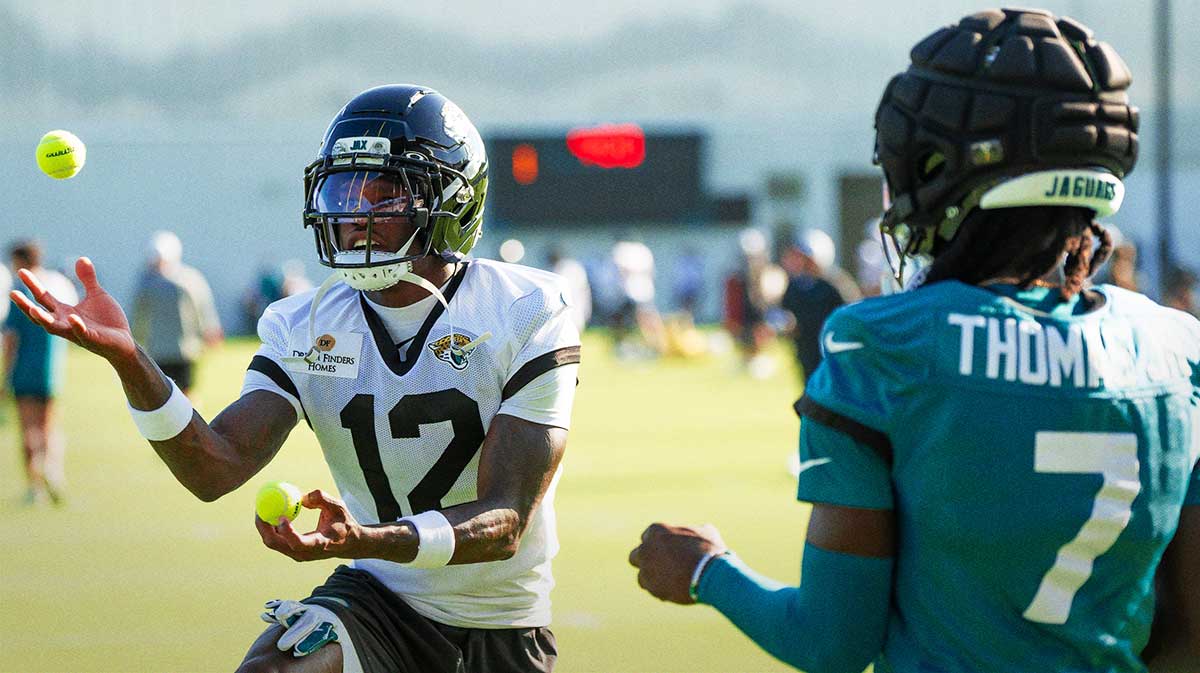 Jacksonville Jaguars wide receiver Travis Hunter (12) and Jacksonville Jaguars wide receiver Brian Thomas Jr. (7) use tennis balls in a drill during an NFL training camp fourth session at the Miller Electric Center, Sunday, July 27, 2025, in Jacksonville, Fla. [Doug Engle/Florida Times-Union]