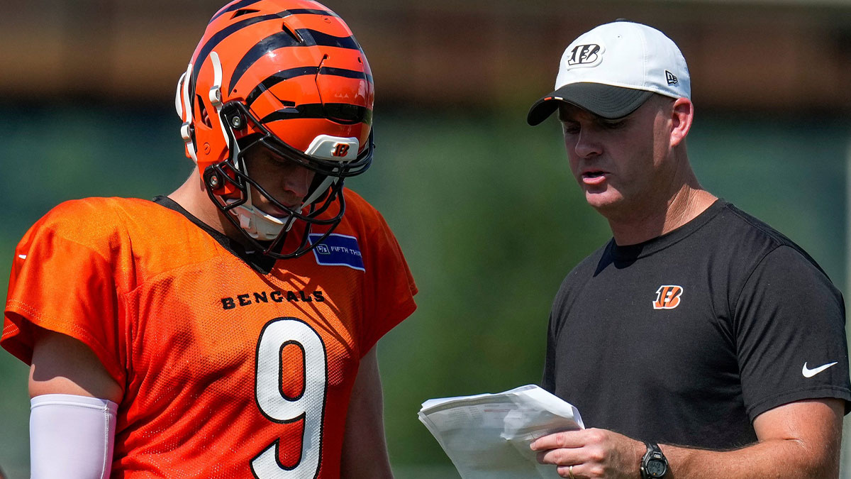 Cincinnati Bengals quarterback Joe Burrow (9) talks with head coach Zac Taylor during a preseason training camp practice in downtown Cincinnati on Wednesday, July 30, 2025.