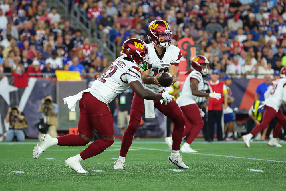 FOXBOROUGH, MA - AUGUST 08: Washington Commanders quarterback Sam Hartman (15) hands off to Washington Commanders running back Jacory Croskey-Merritt (32) during the NFL preseason game between Washington Commanders and New England Patriots on August 8, 2025, at Gillette Stadium in Foxborough, MA. (Photo by M. Anthony Nesmith/Icon Sportswire)