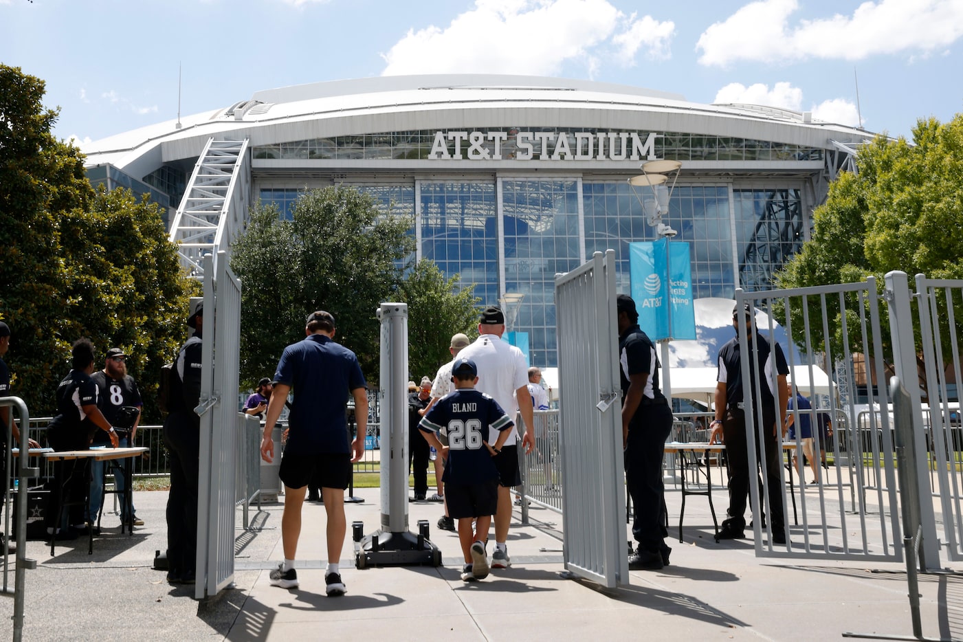 Fans arrive at AT&T Stadium before an NFL preseason football game between the Dallas Cowboys...