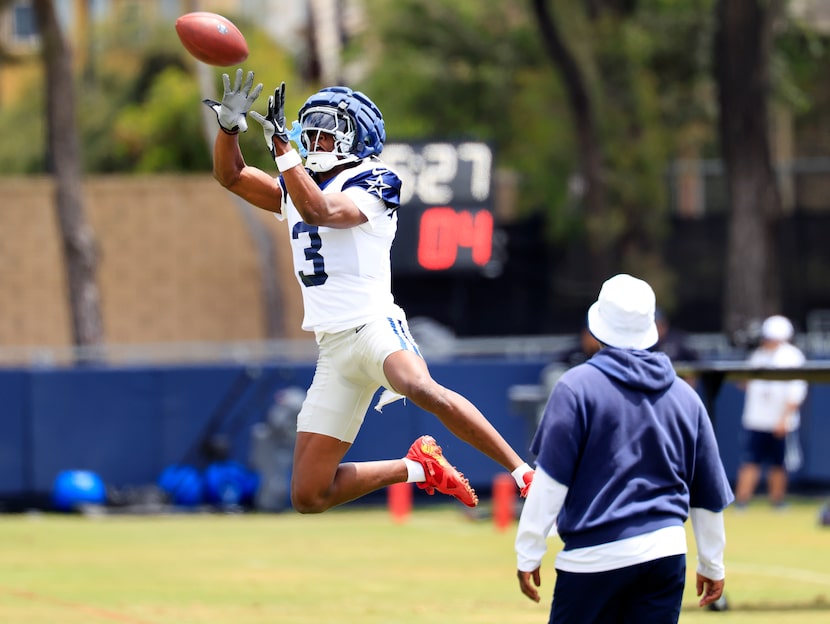 Dallas Cowboys wide receiver George Pickens (3) leaps for a high pass during training camp...