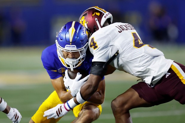 San Jose State wide receiver Matthew Coleman (14) is tackled...