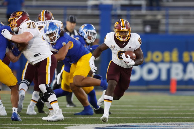 Central Michigan running back Trey Cornist (6) runs the ball...